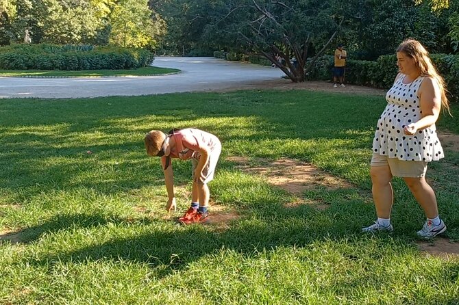 Athens with Kids: Myths & Family Games in the National Garden - Ancient toys on a mat beneath the trees
