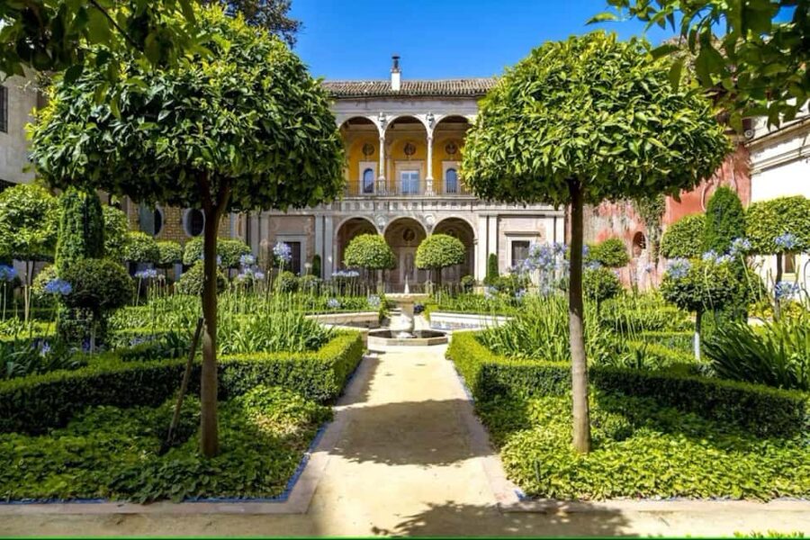 Seville: Guided Tour of Noble Houses and Grand Gardens - Casa Pilatos and its blue-and-white courtyard